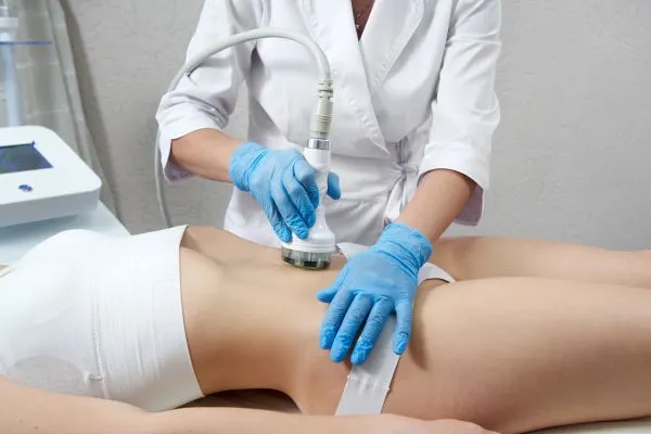 Lost the Weight but Not the Loose Skin? 2 woman having HIFU treatment on her stomach to combat loose skin Bishop's Stortford following weight loss